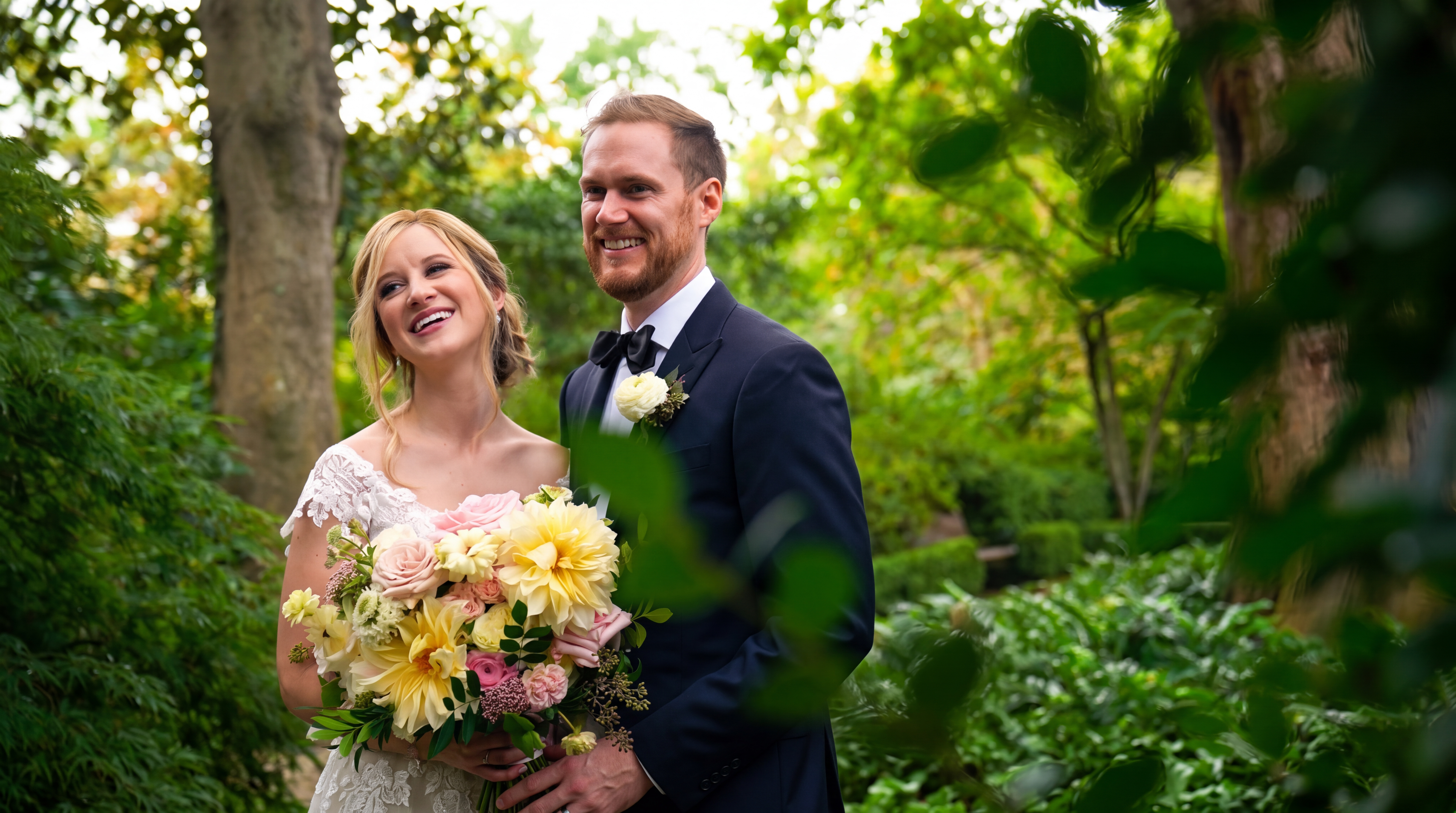 Bride and groom smiling together during an outdoor wedding portrait